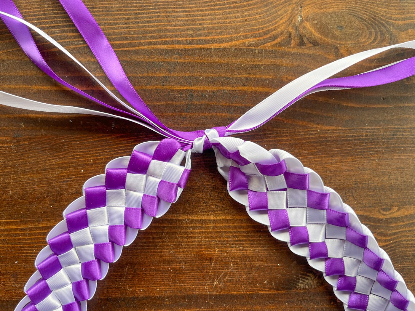 tying the ends of a ribbon lei together