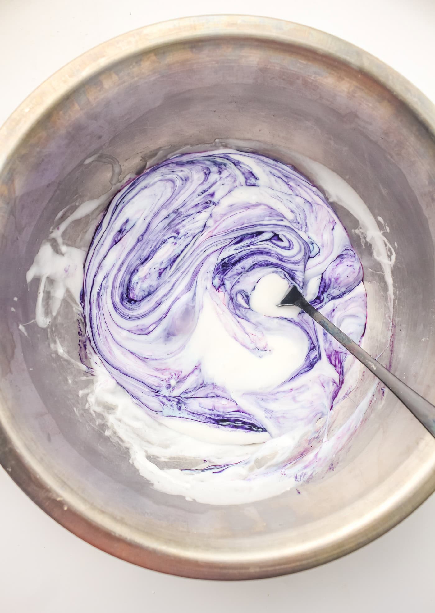 mixing food coloring into DIY slime