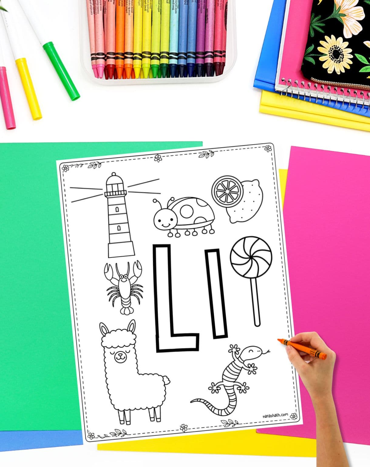 a hand with a crayon preparing to color a letter l themed coloring sheet