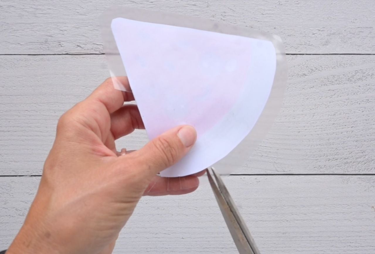 cutting tabs in contact paper around a paper squishy watermelon