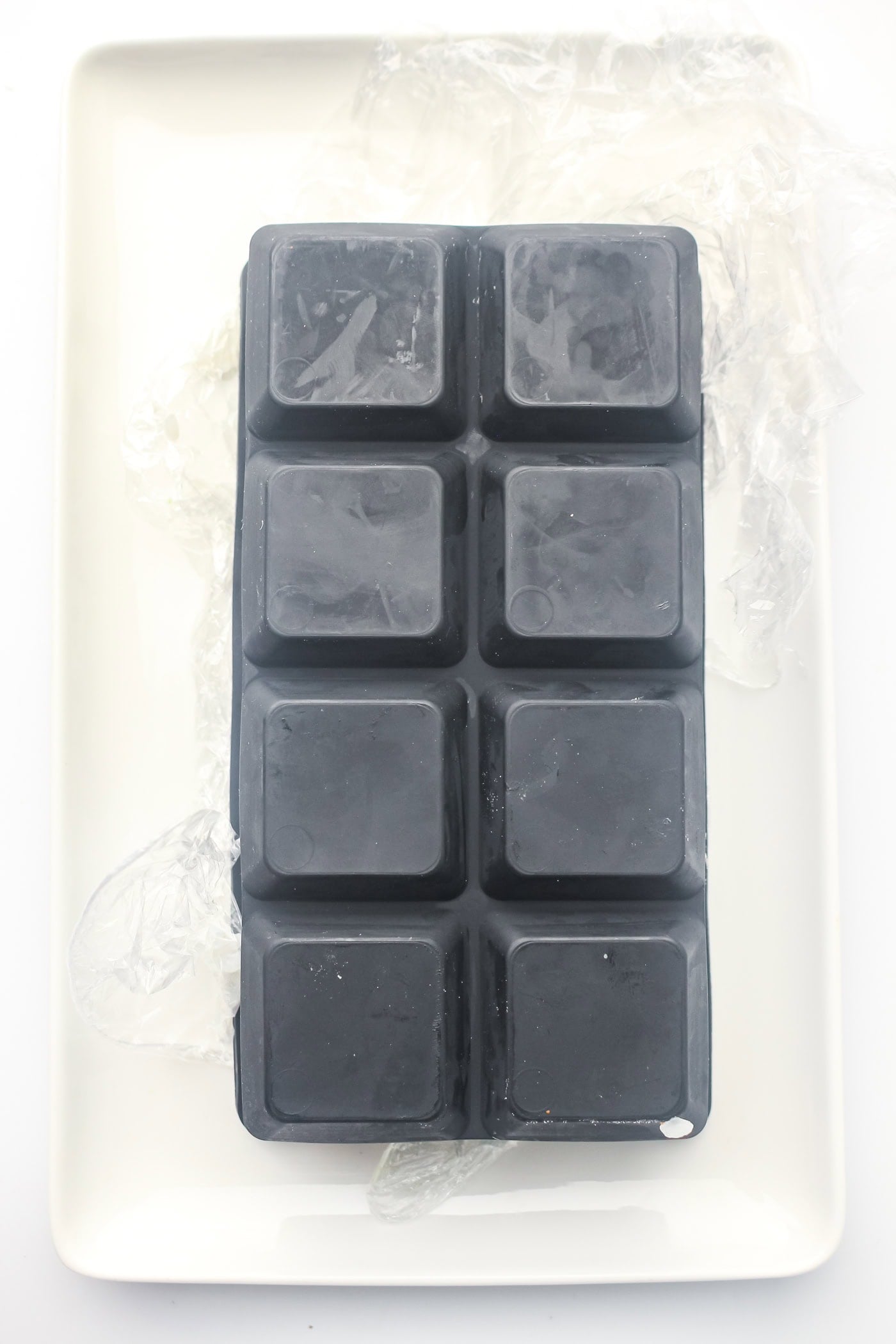 a silicone ice cube tray upside down on a platter for ice cube tray sushi salmon rolls