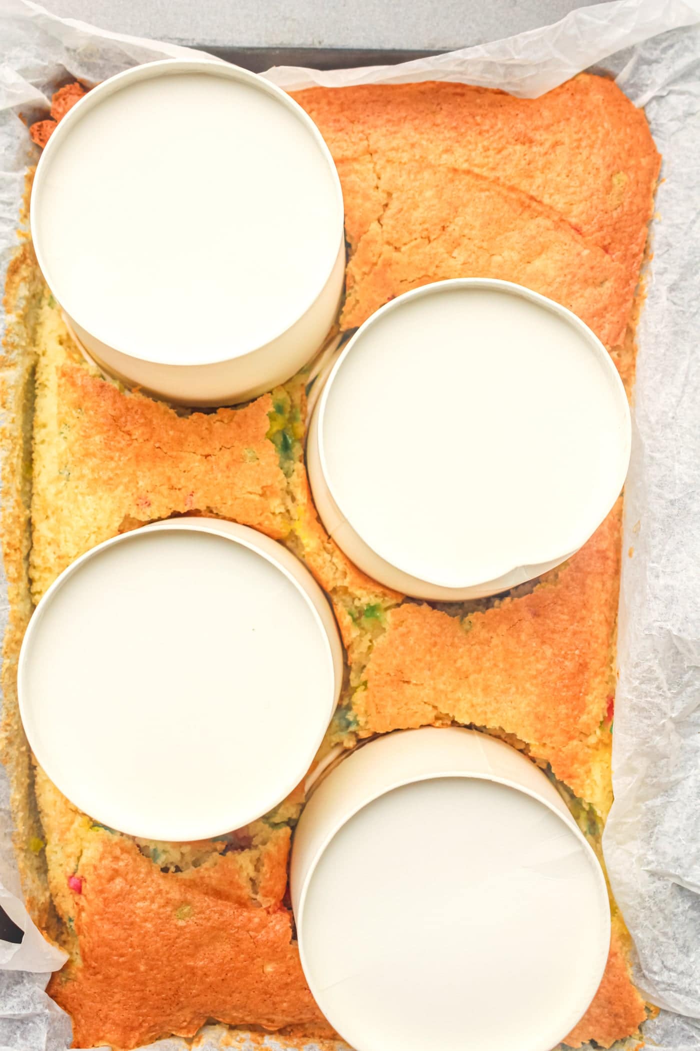 pressing paper dessert cups into a cake to make gluten free dot cakes