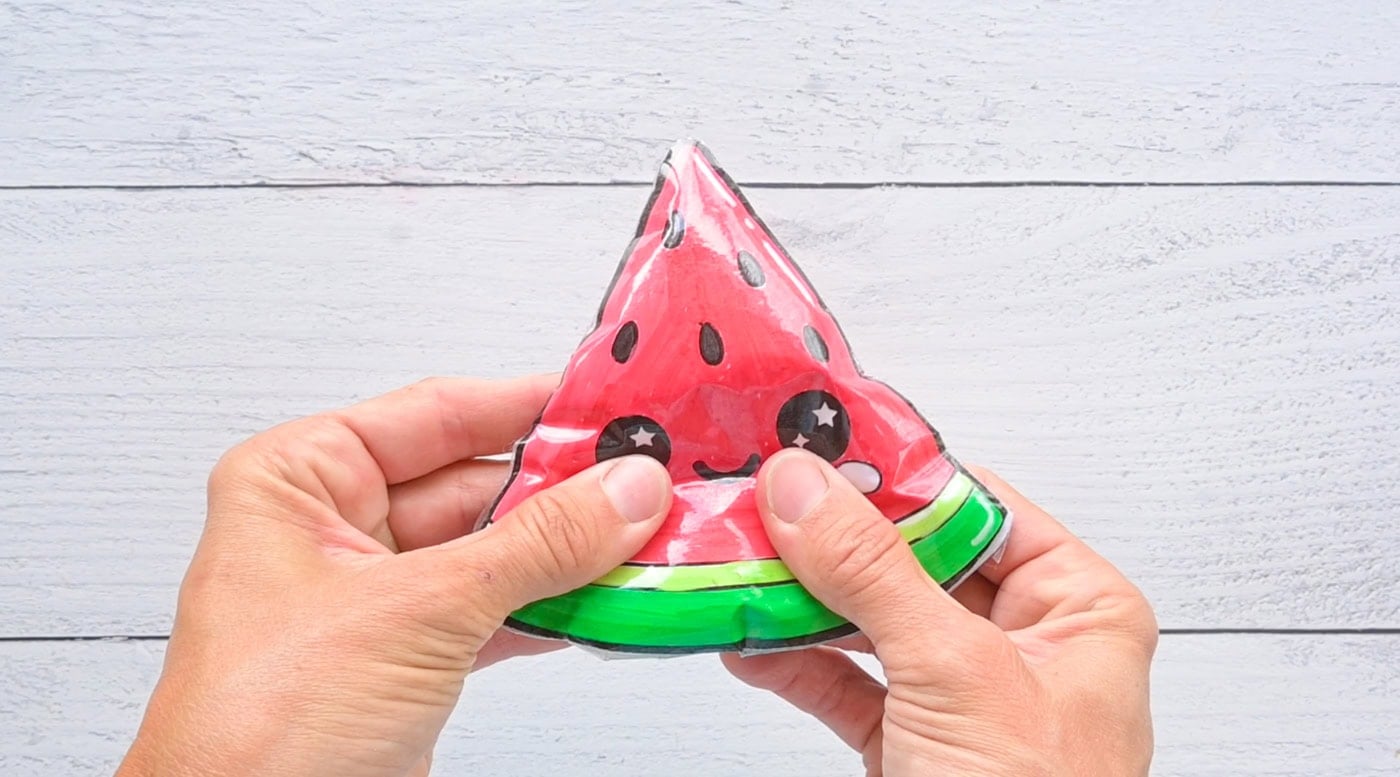 squishing a paper squishy watermelon