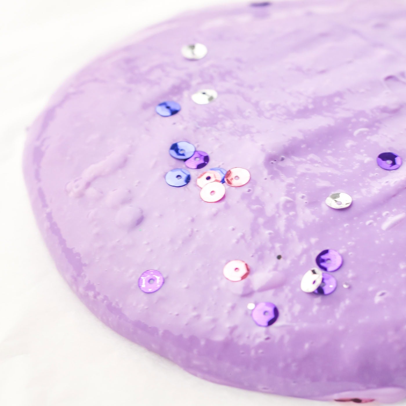 purple DIY sensory slime with purple and pink sequins 