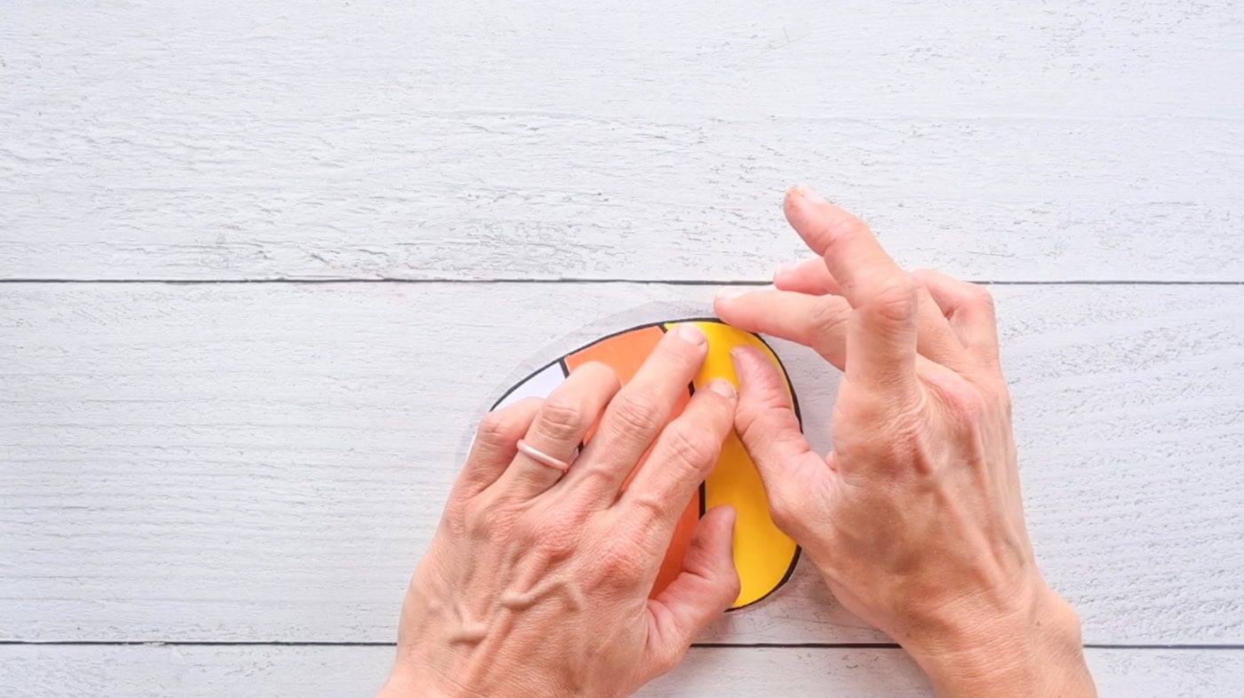using tabs cut into contact paper to adhere the front and back pieces of a diy candy corn together