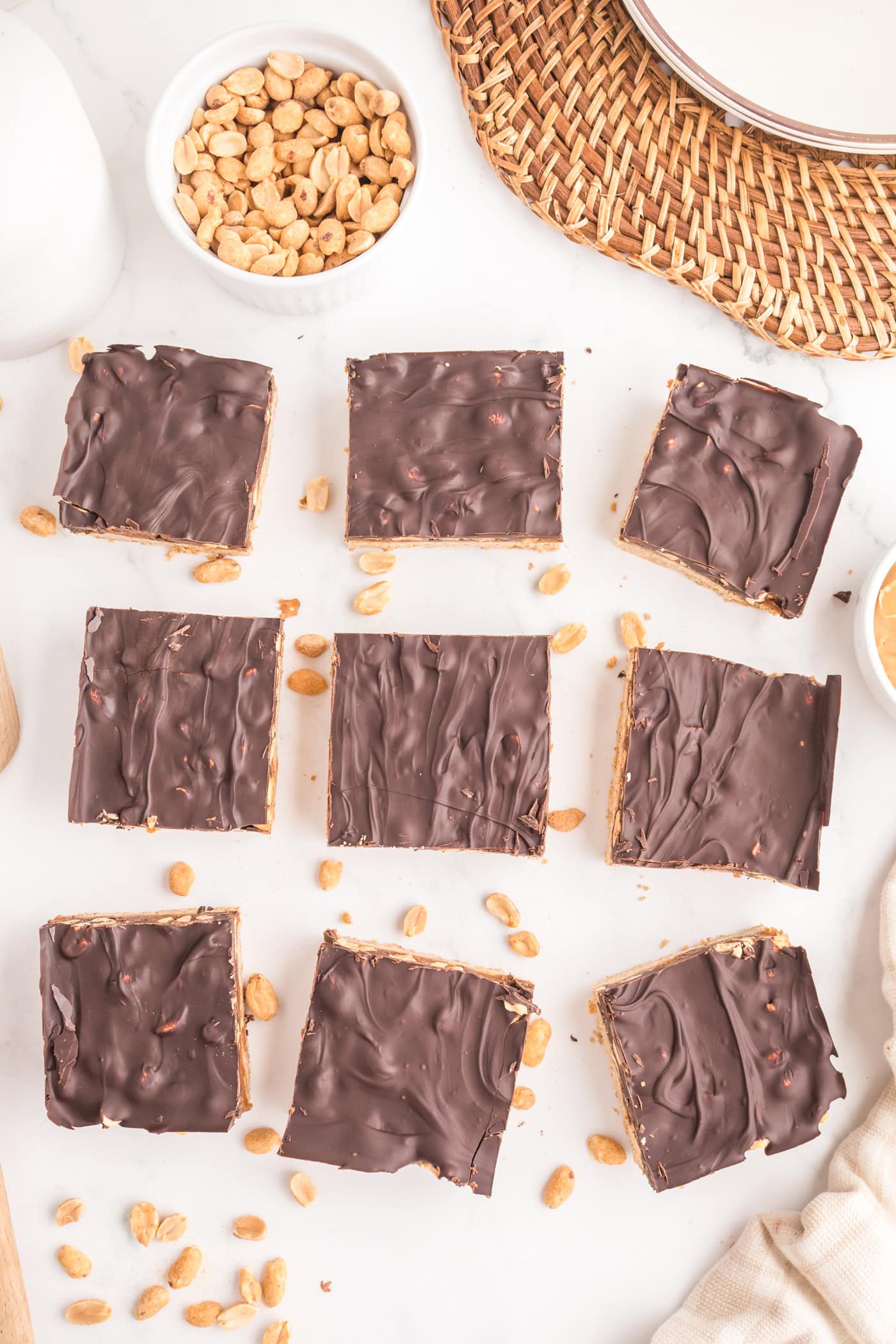 a top down view dairy free healthy snickers bars with scattered peanuts