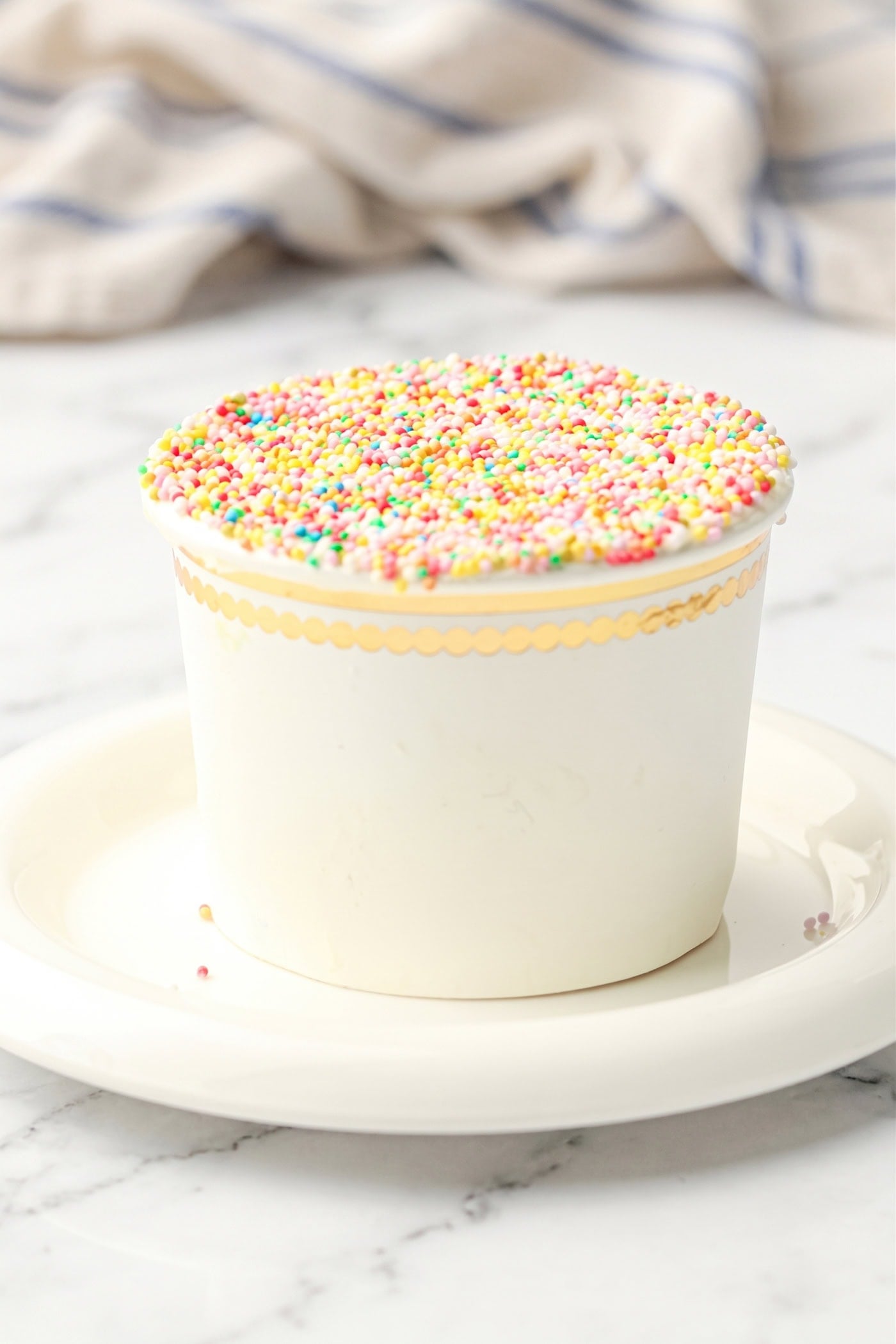 a gluten free dot cake in a white cup on a saucer