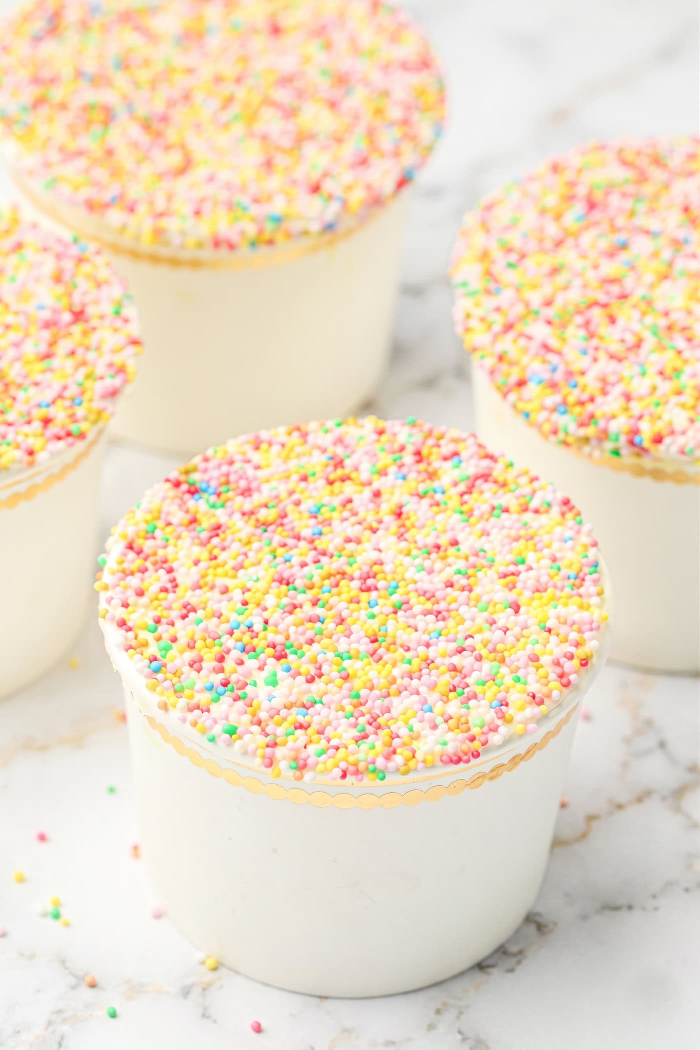 four gluten free dot cakes in ice cream cups