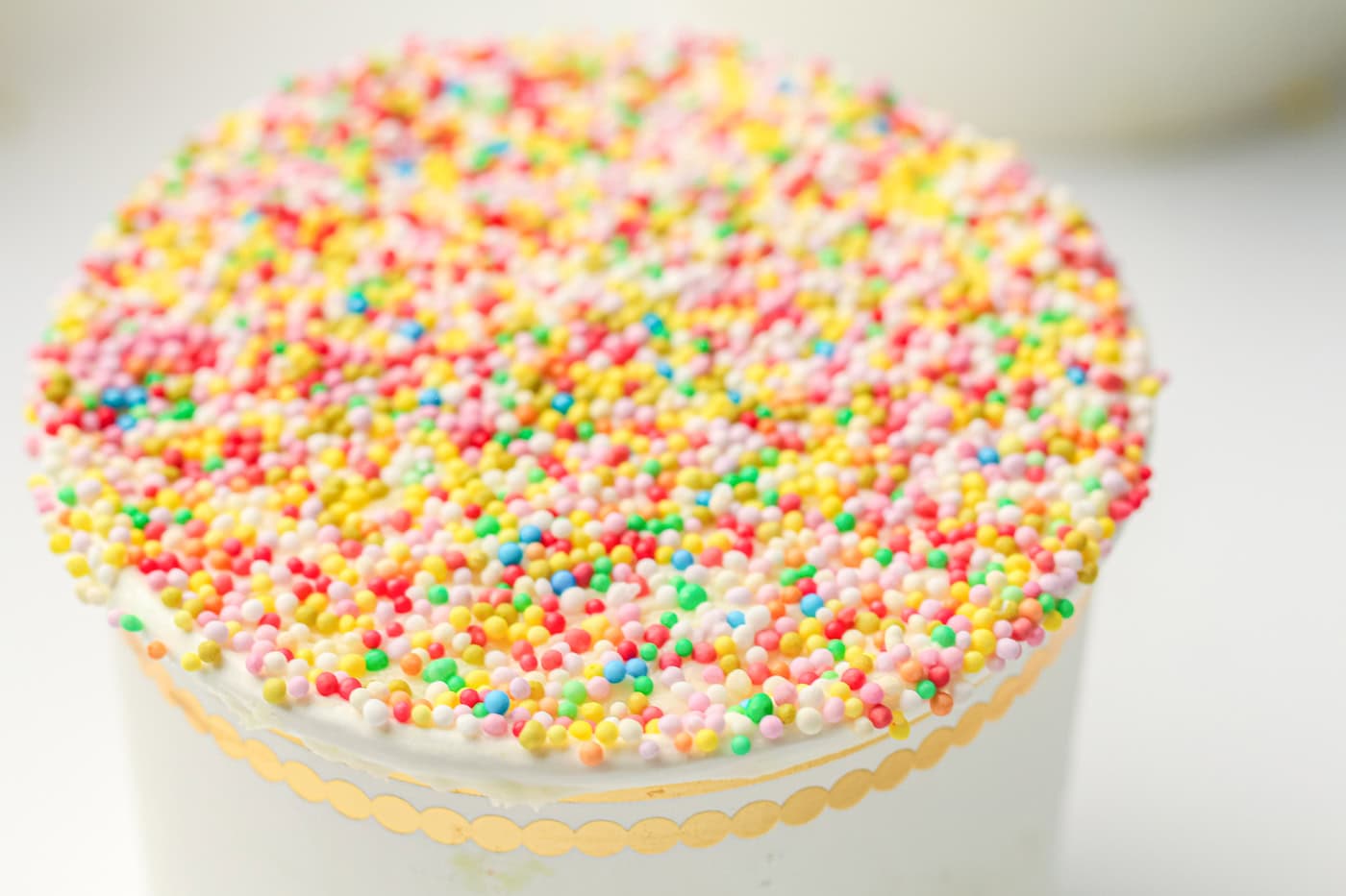 a close up of the top of a gluten free sprinkle crunch cake