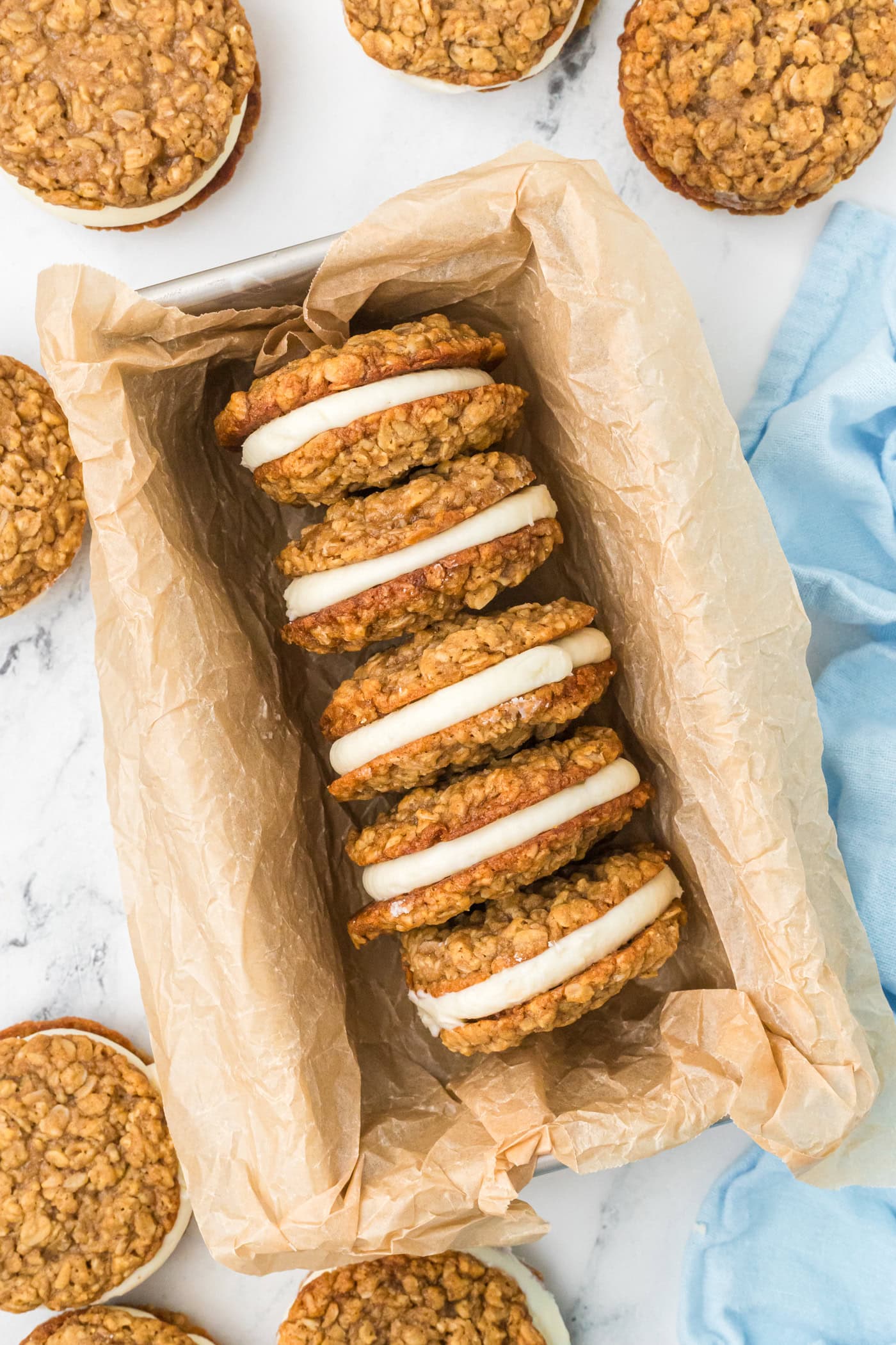 a top down photo of homemade oatmeal cream pies in a loaf pan with parchment paper