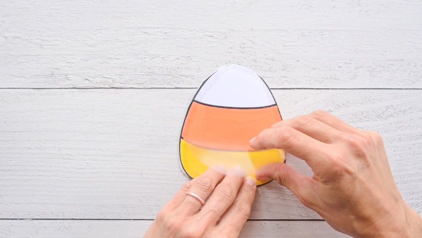 laminating the back of a diy paper candy corn squishy with contact paper