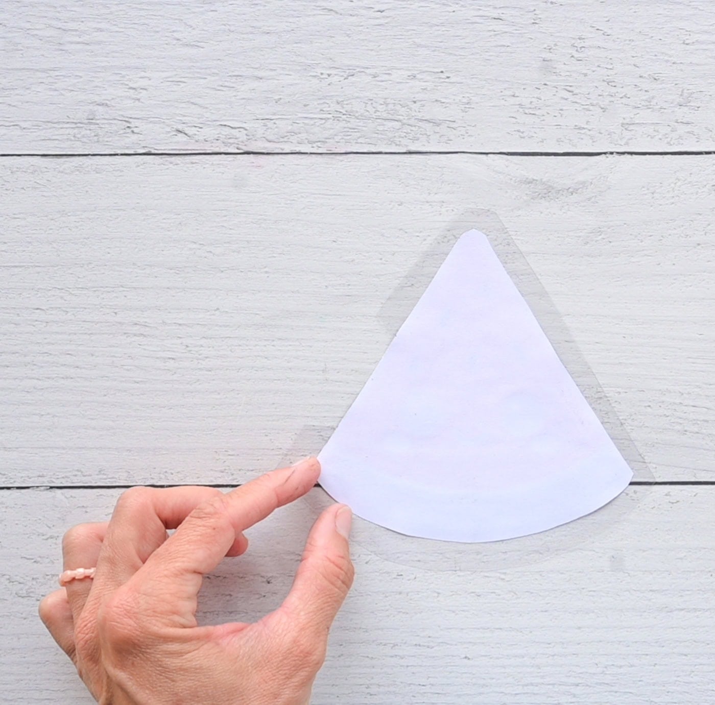 placing a template for a paper squishy watermelon face down on contact paper