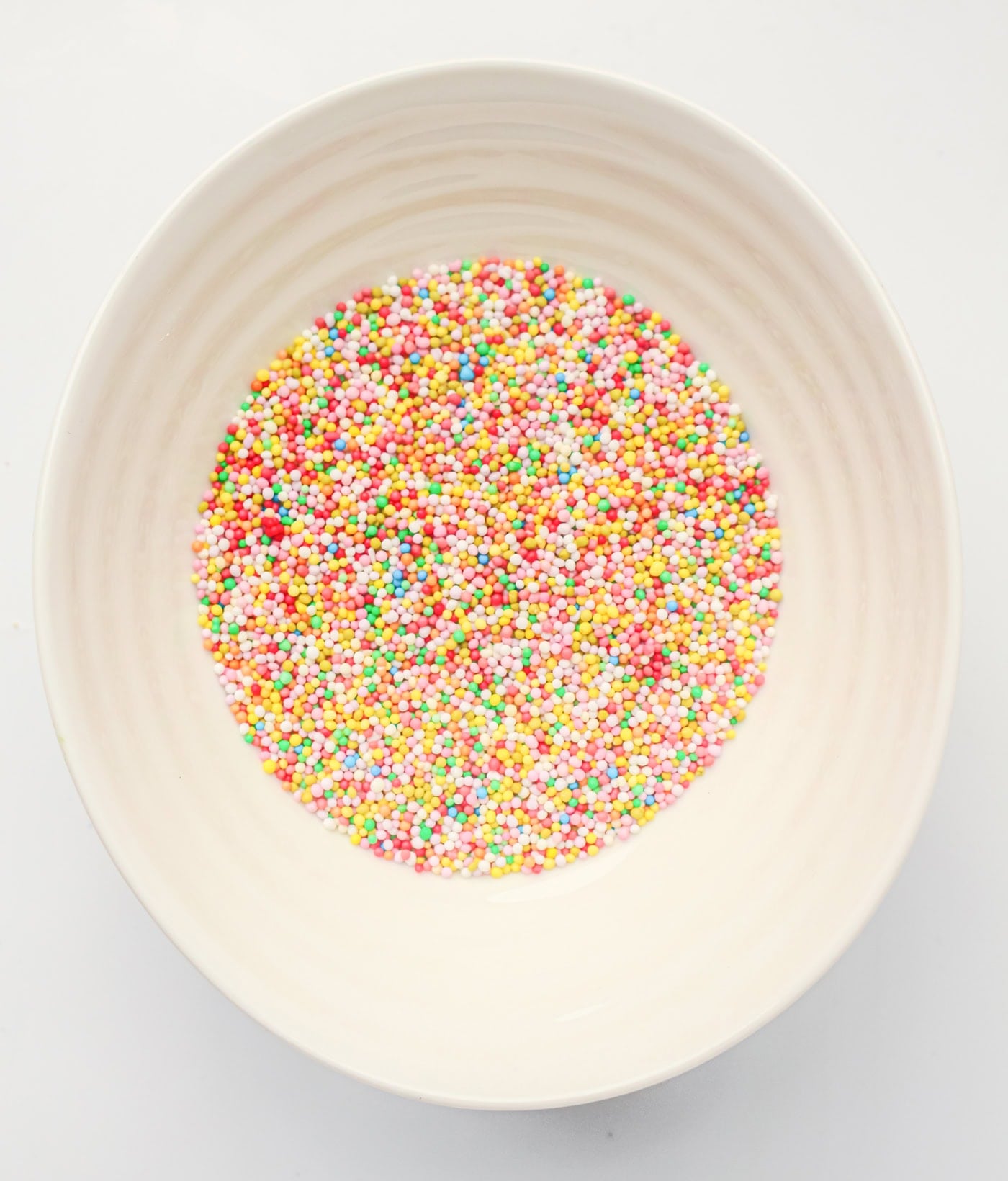 a bowl of sprinkles for making a gluten free dot cake