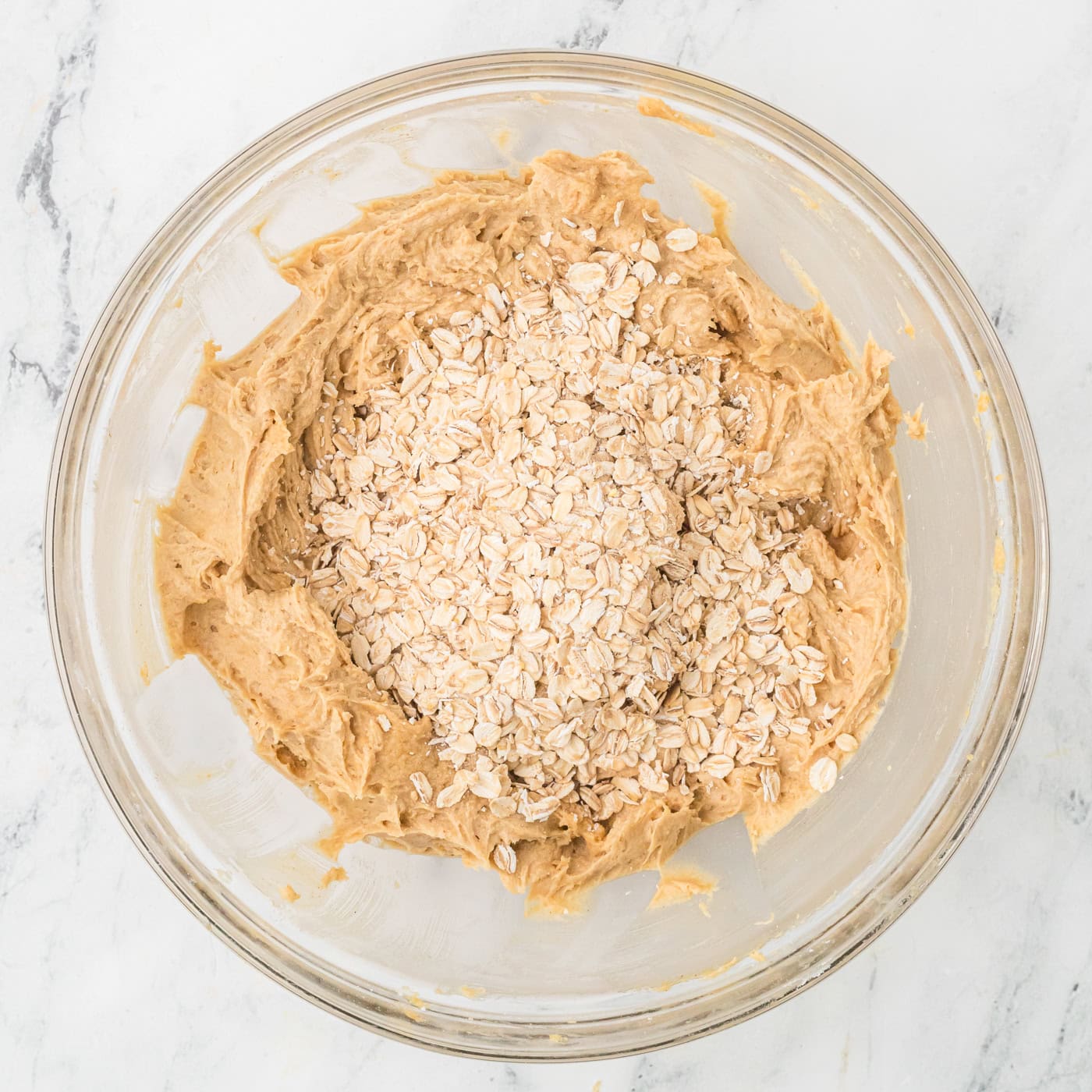 adding oatmeal to dough for making homemade oatmeal cream pies