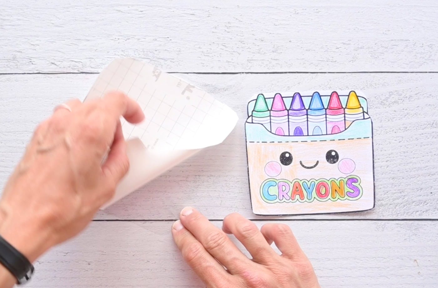 laminating the front of a box of crayons paper squishy with contact paper