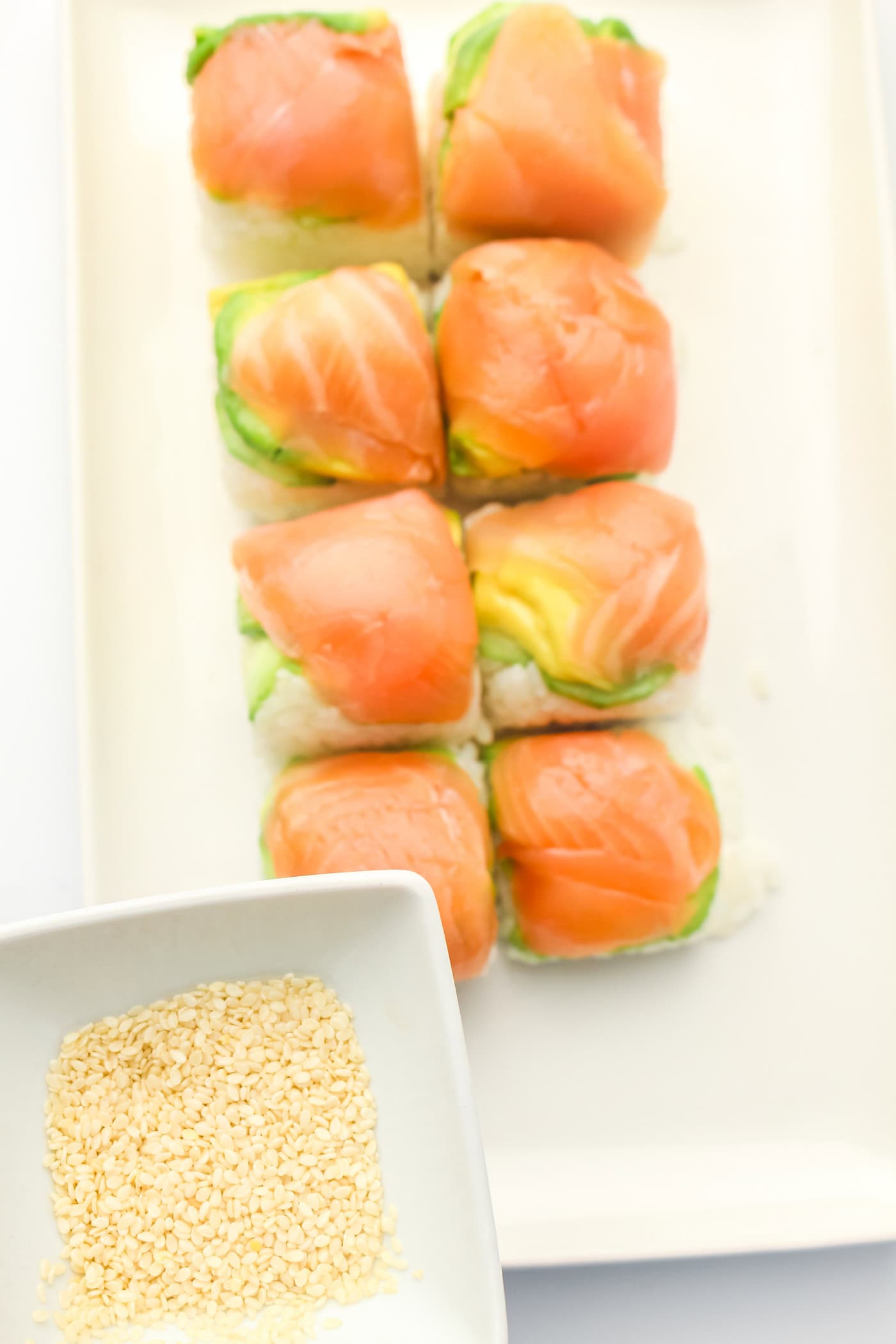 adding sesame seeds to ice cube tray sushi salmon rolls