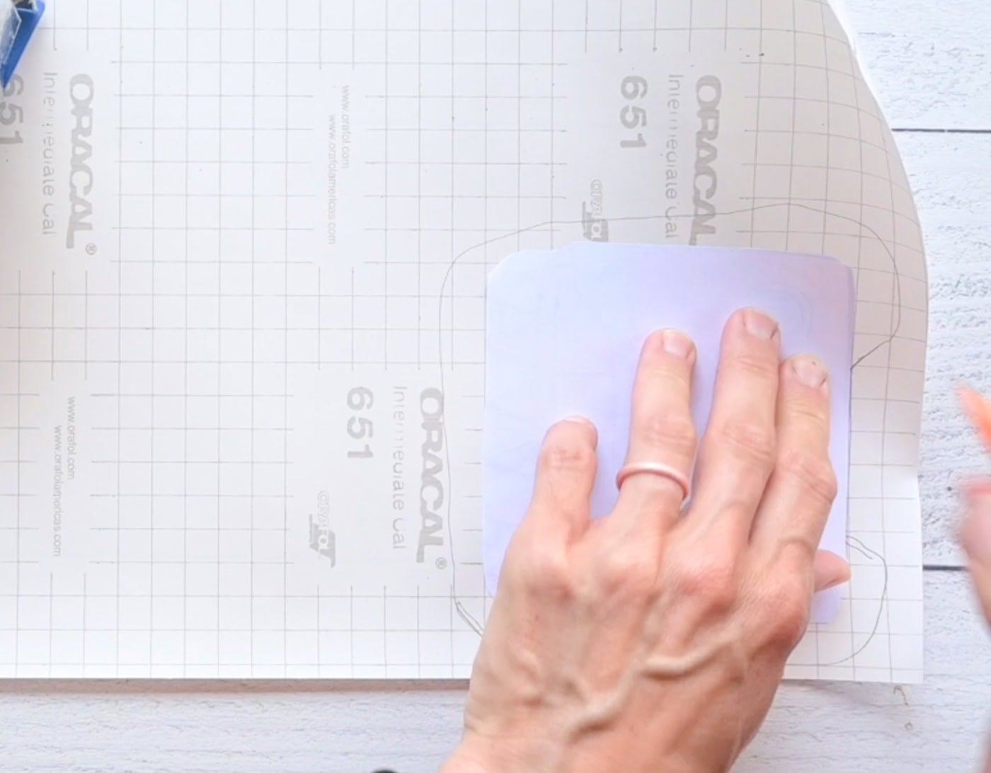 tracing a paper cut out to make a diy paper squishy onto contact paper