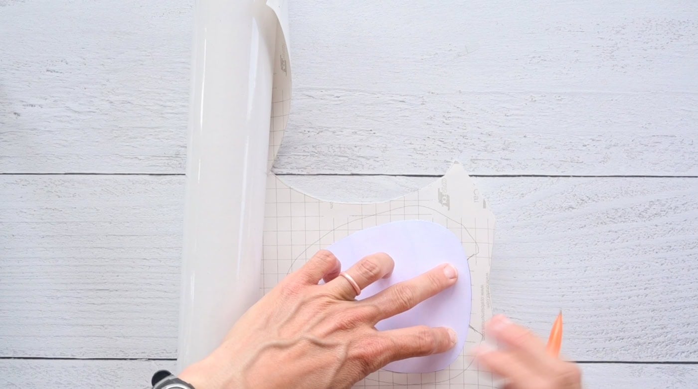 tracing the front of a candy corn squishy template onto contact paper