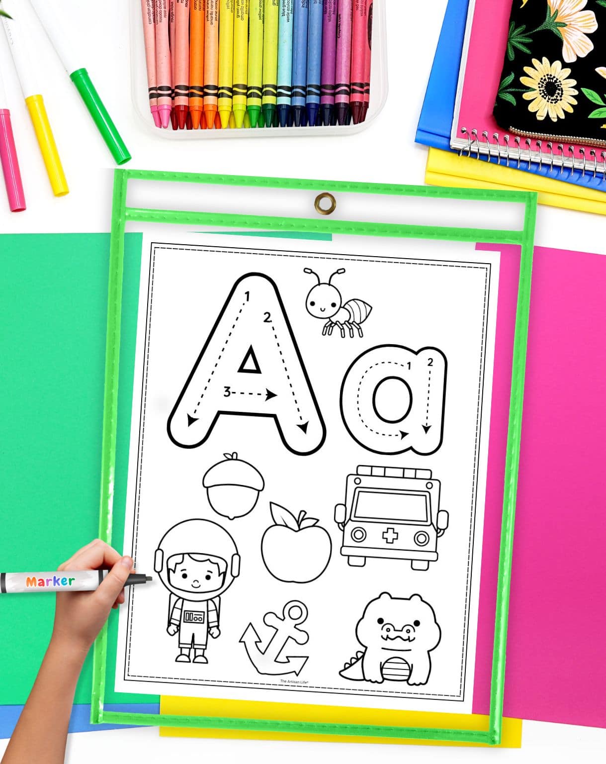 a hand with a dry erase marker preparing to use a letter a coloring page that is inside a dry erase pocket