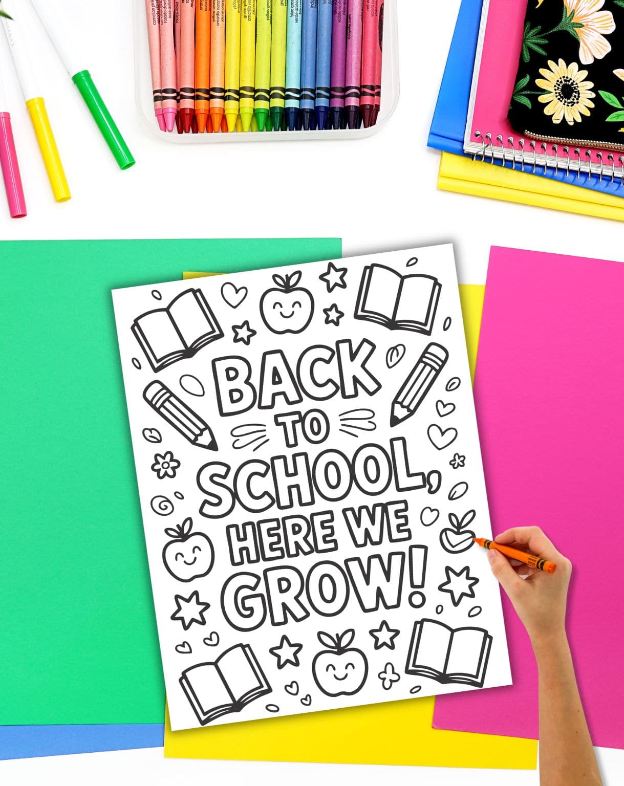 a hand preparing to color a positive back to school coloring page with the message "back to school here we grow!"