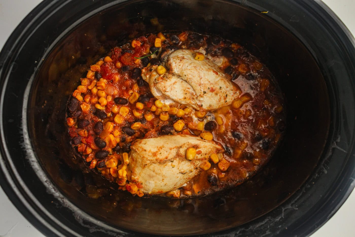 salsa slow cooker chicken in a crock pot before shredding