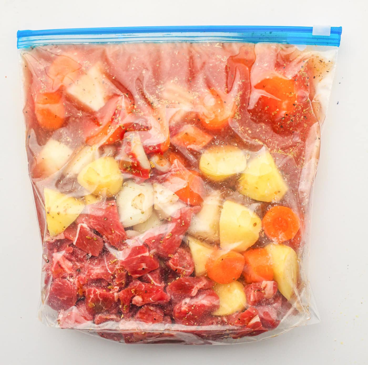 a gallon zip lock bag with ingredients for beef stew