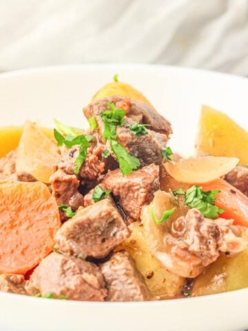 a white bowl of slow cooker beef stew