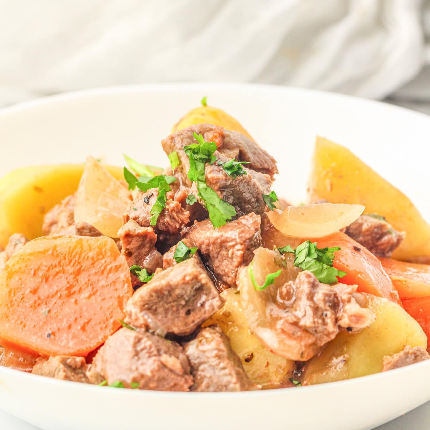 a white bowl of slow cooker beef stew