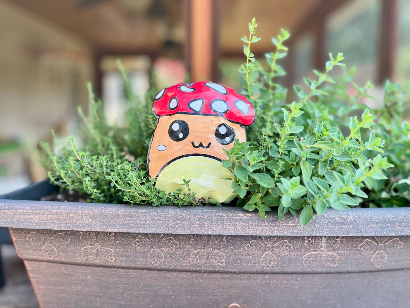 a mushroom paper squishy in a planter with oregano and thyme