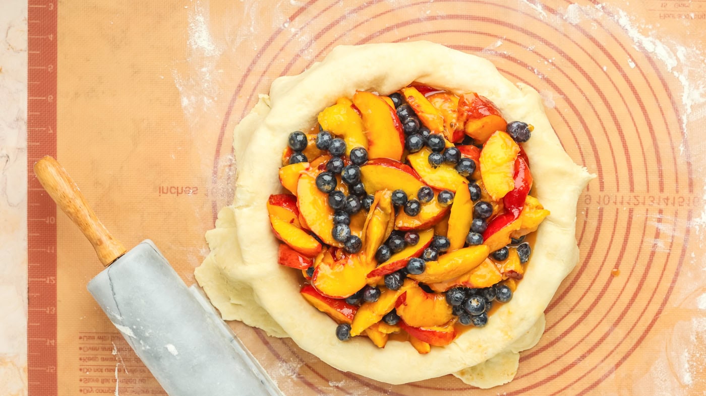 fresh peach and blueberry filling I the bottom half of a pie crust