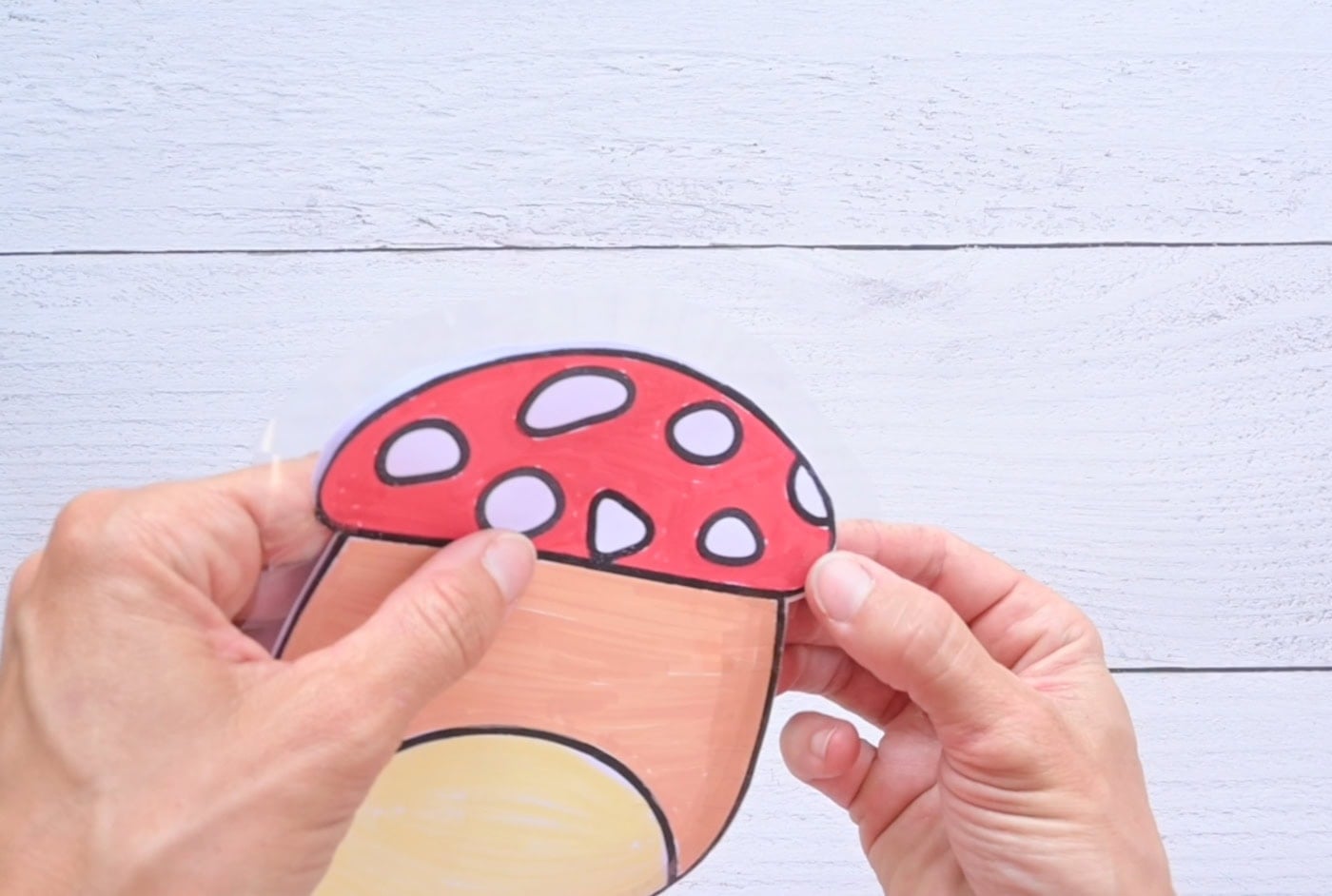 taping the back and front of a mushroom squishy together