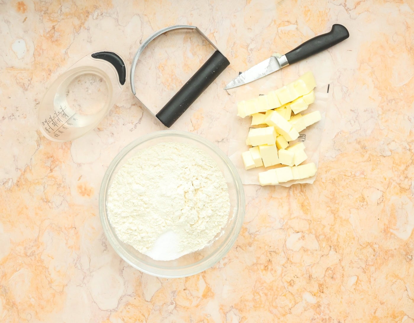 flour and butter with a pastry cutter for making pie crust