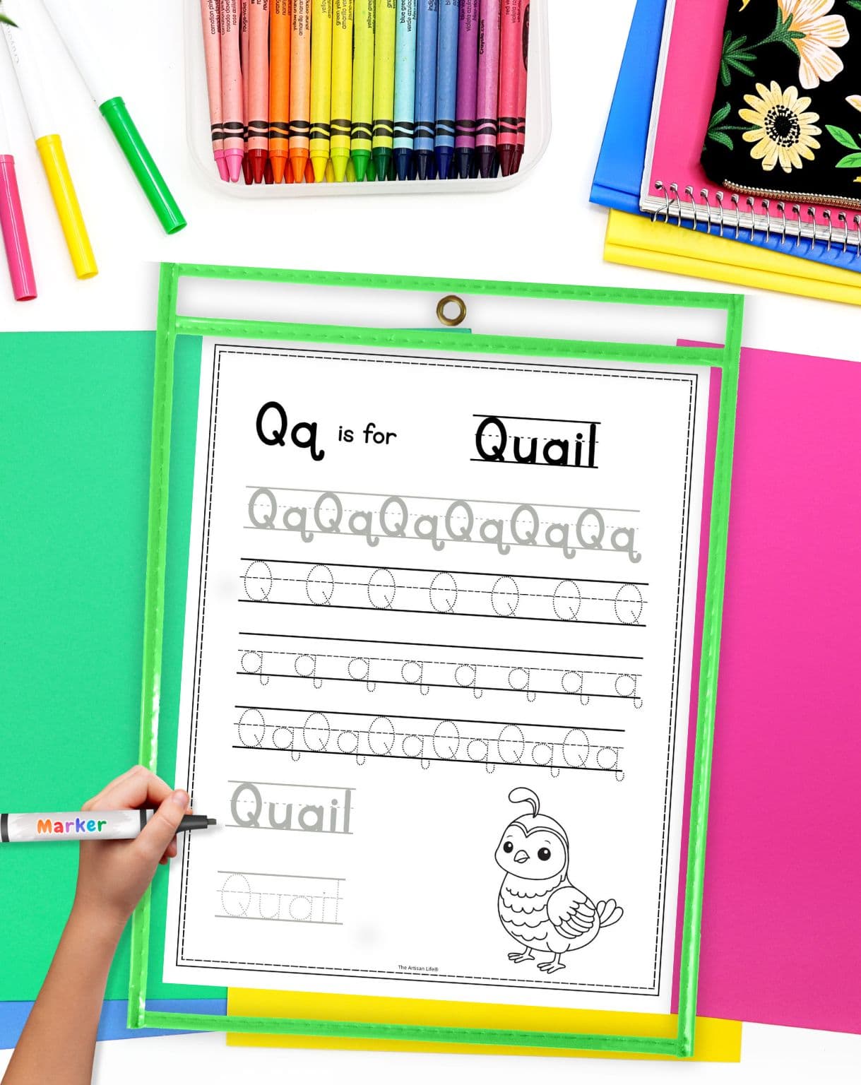 A letter q tracing page in a dry erase pocket