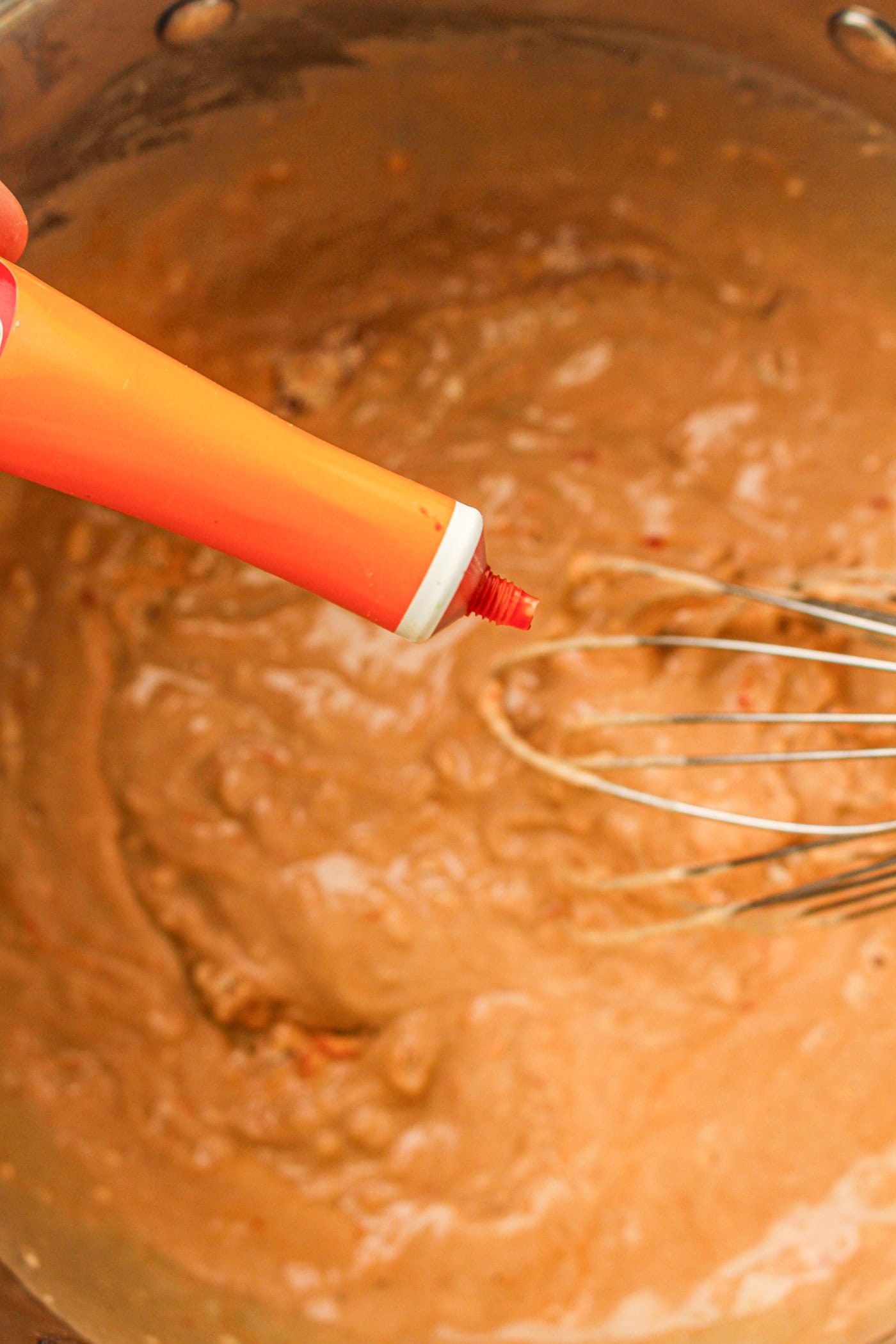 adding food coloring to homemade fall play dough
