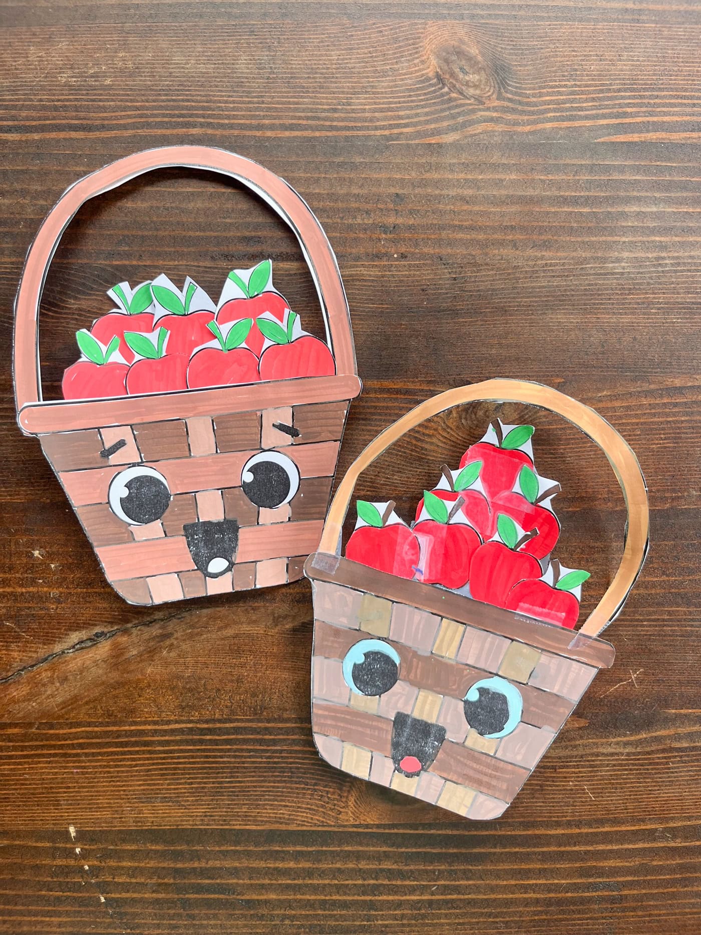 two completed cuts and paste apple basket crafts for children