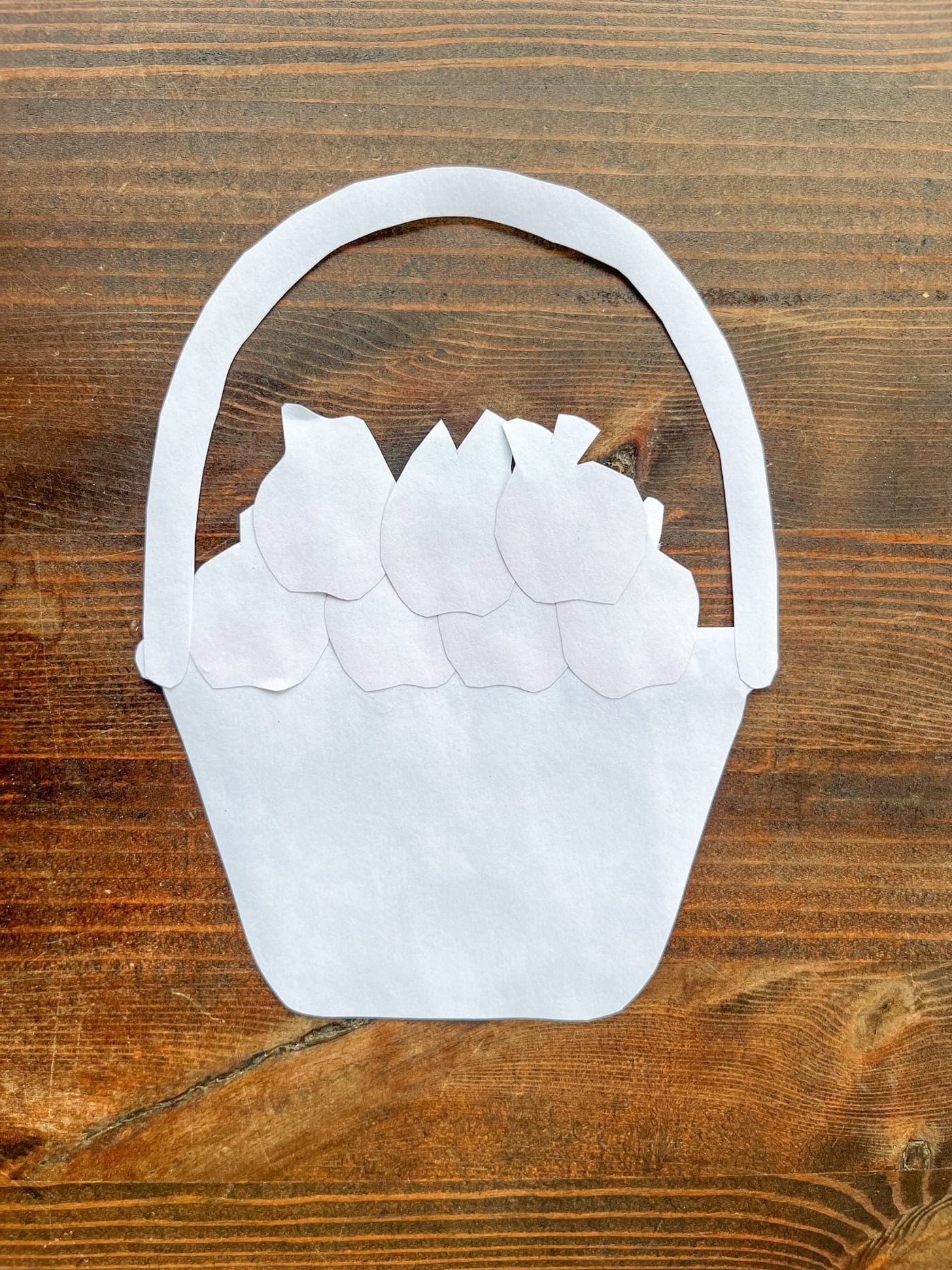 the back of a completed child's cut and paste apple basket craft