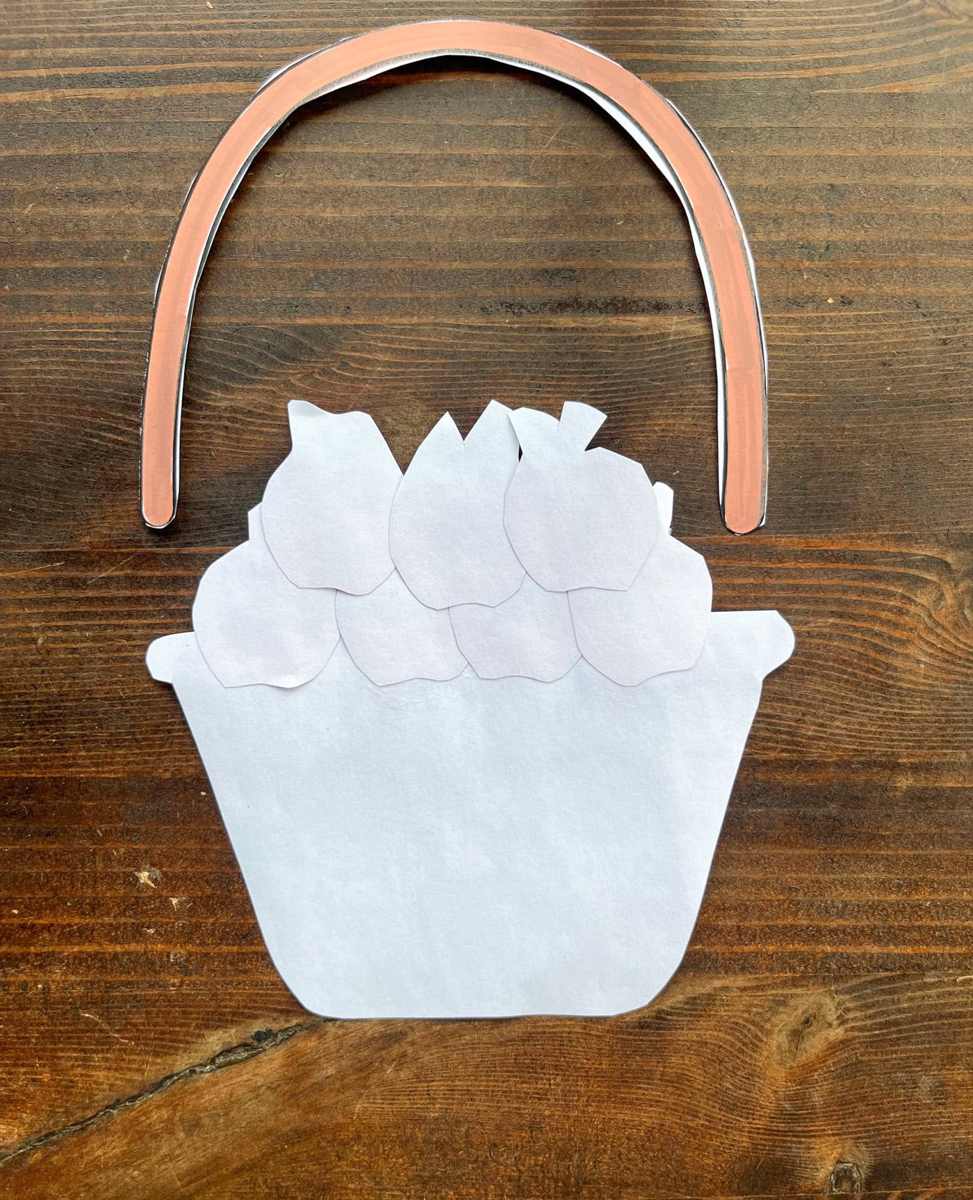 the back of a cut and paste basket and apples with a handle piece to glue in place
