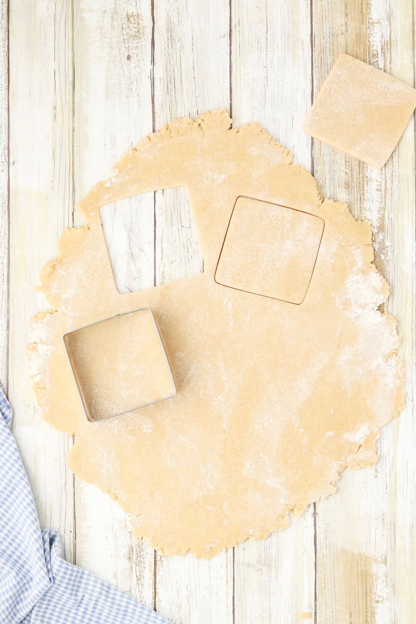 cutting out square cookies for chalkboard sugar cookies