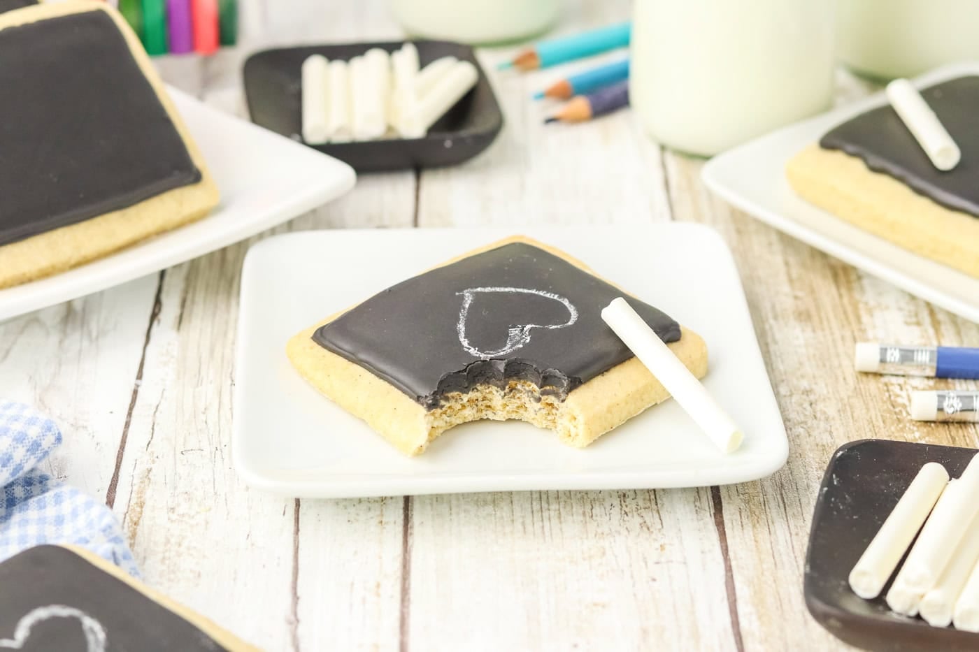 a chalkboard sugar cookie with a bite taken out of it
