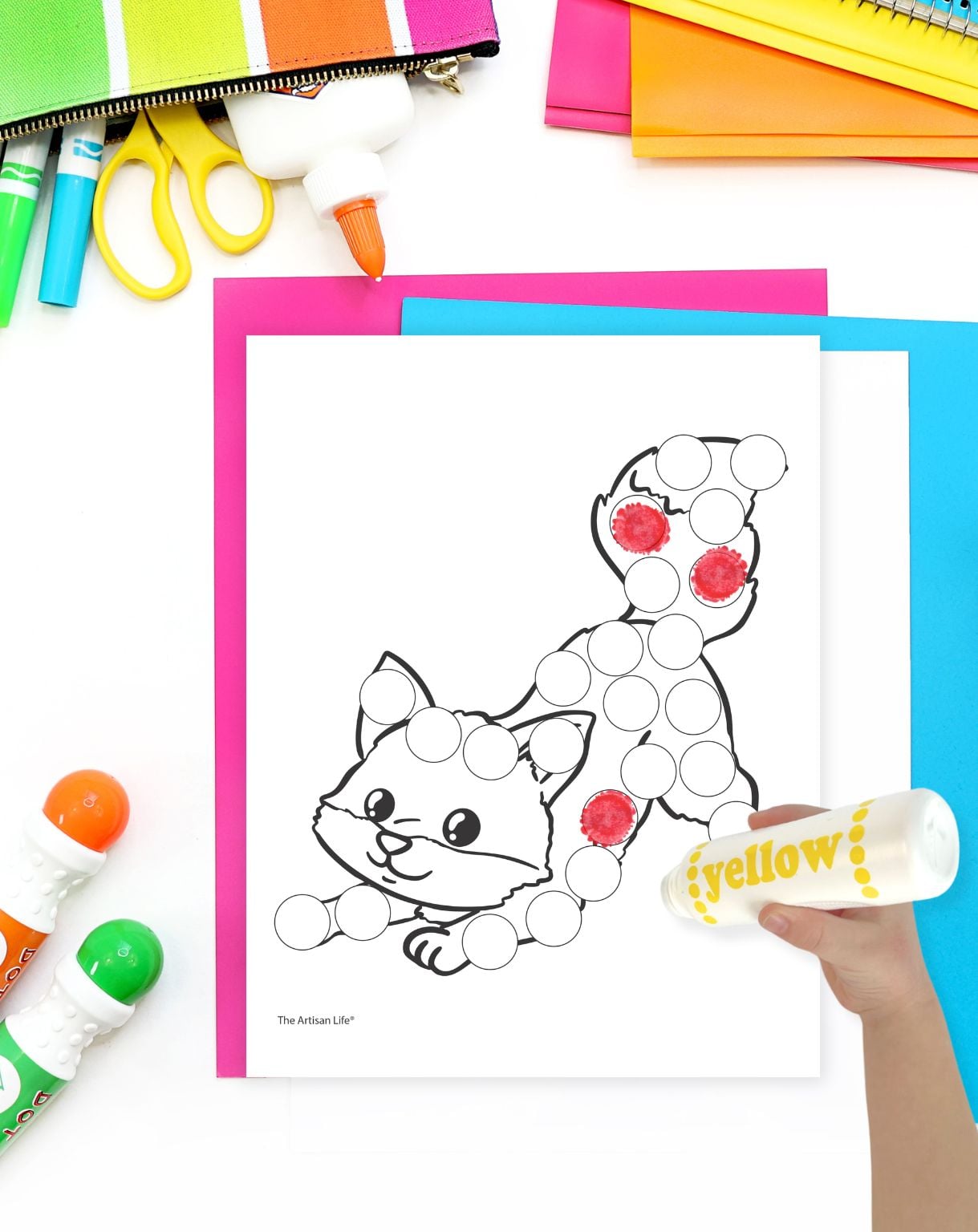 a hand with a yellow dot marker marker preparing to color a fall fox dot marker coloring page