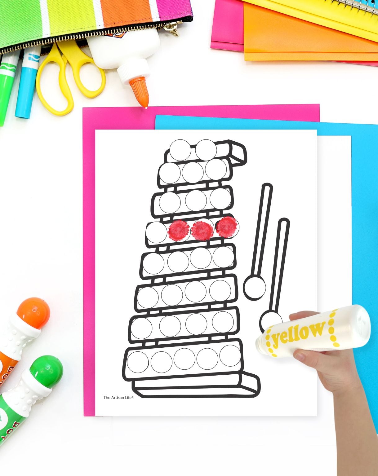 a zither dot marker coloring page with a hand with a dauber marker