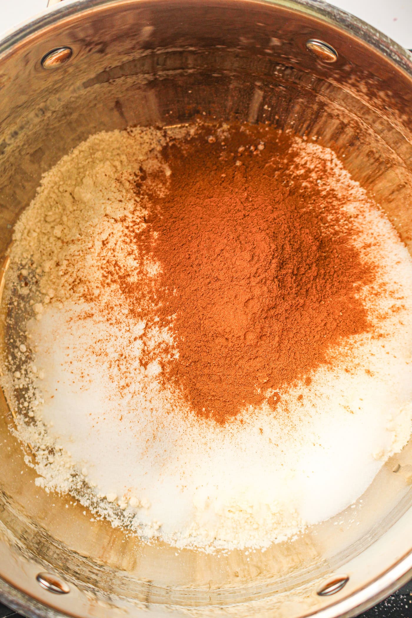 adding dry ingredients for homemade fall play dough