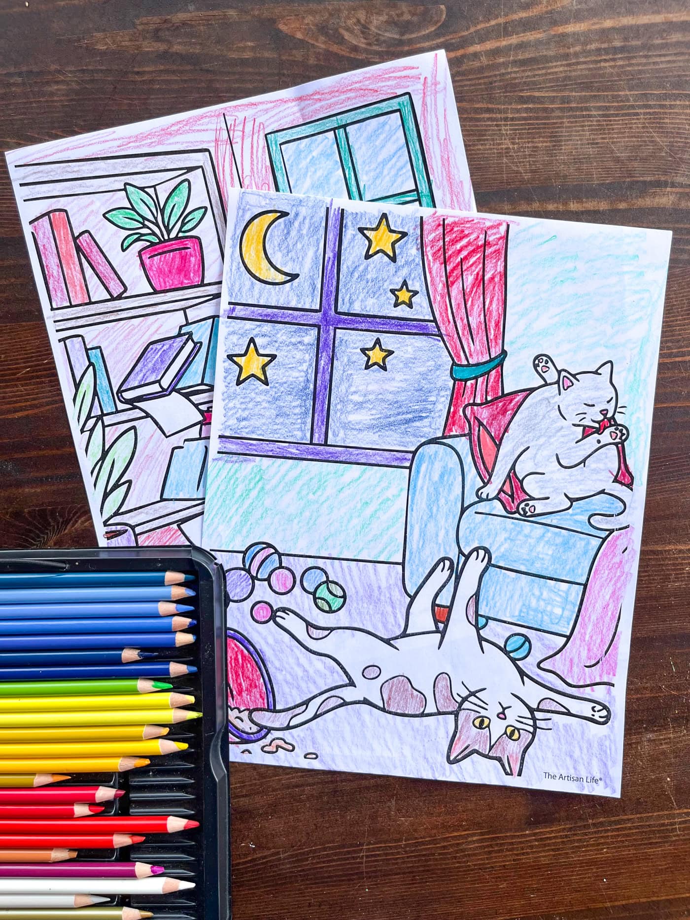 two printed and colored coloring sheets of cats misbehaving in a wrecked room with books and toys on the floor