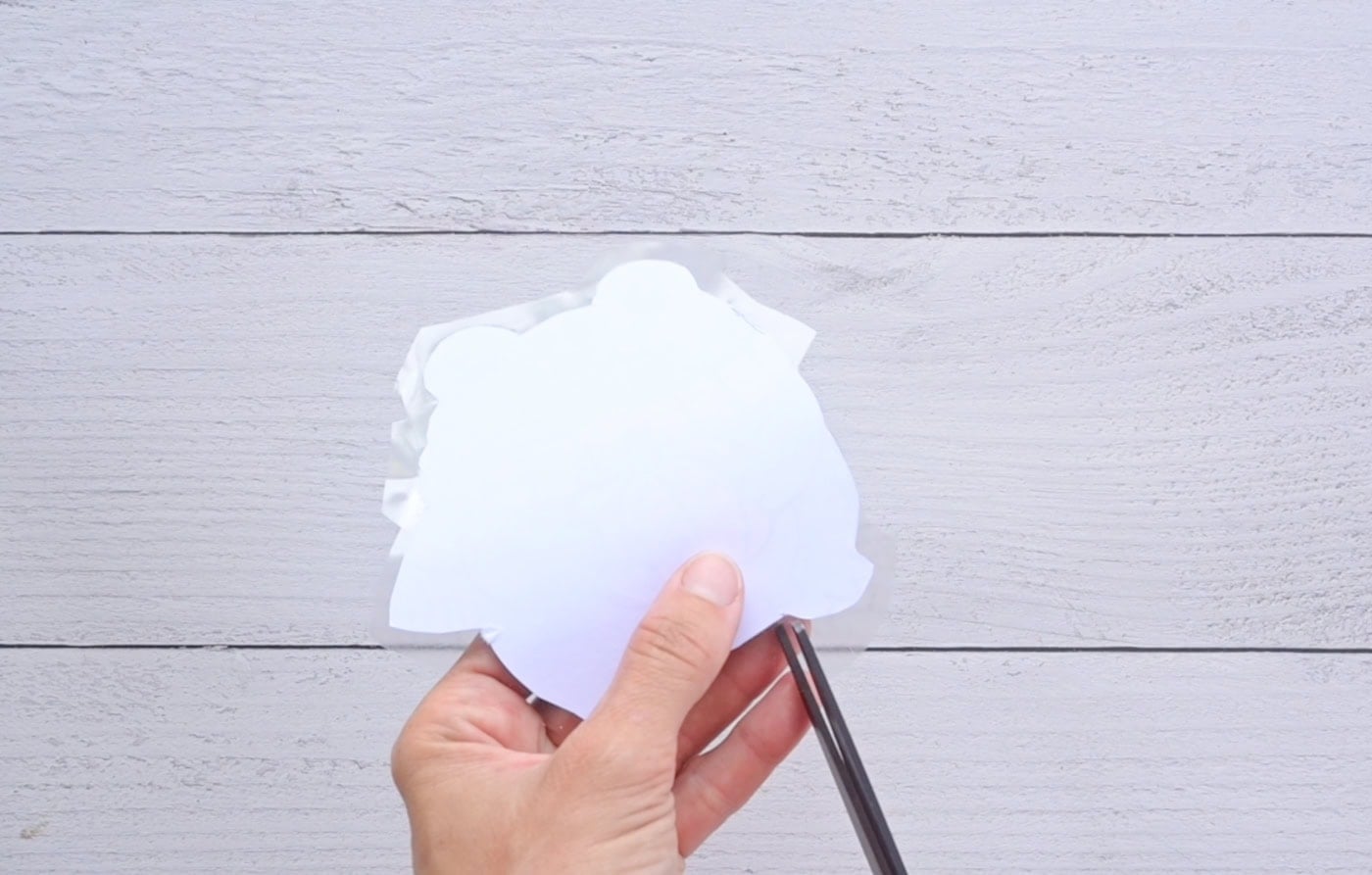 cutting tabs in contact paper to make a fall frog squishy