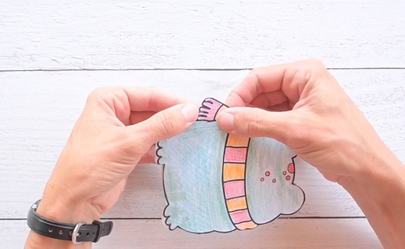 folding tabs of contact paper to close up a paper frog squishy