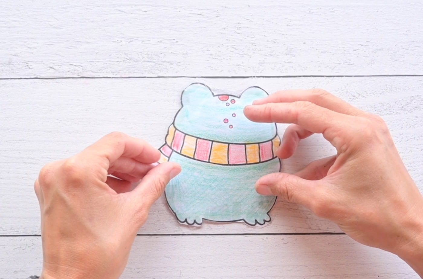 laminating the back of a frog paper squishy
