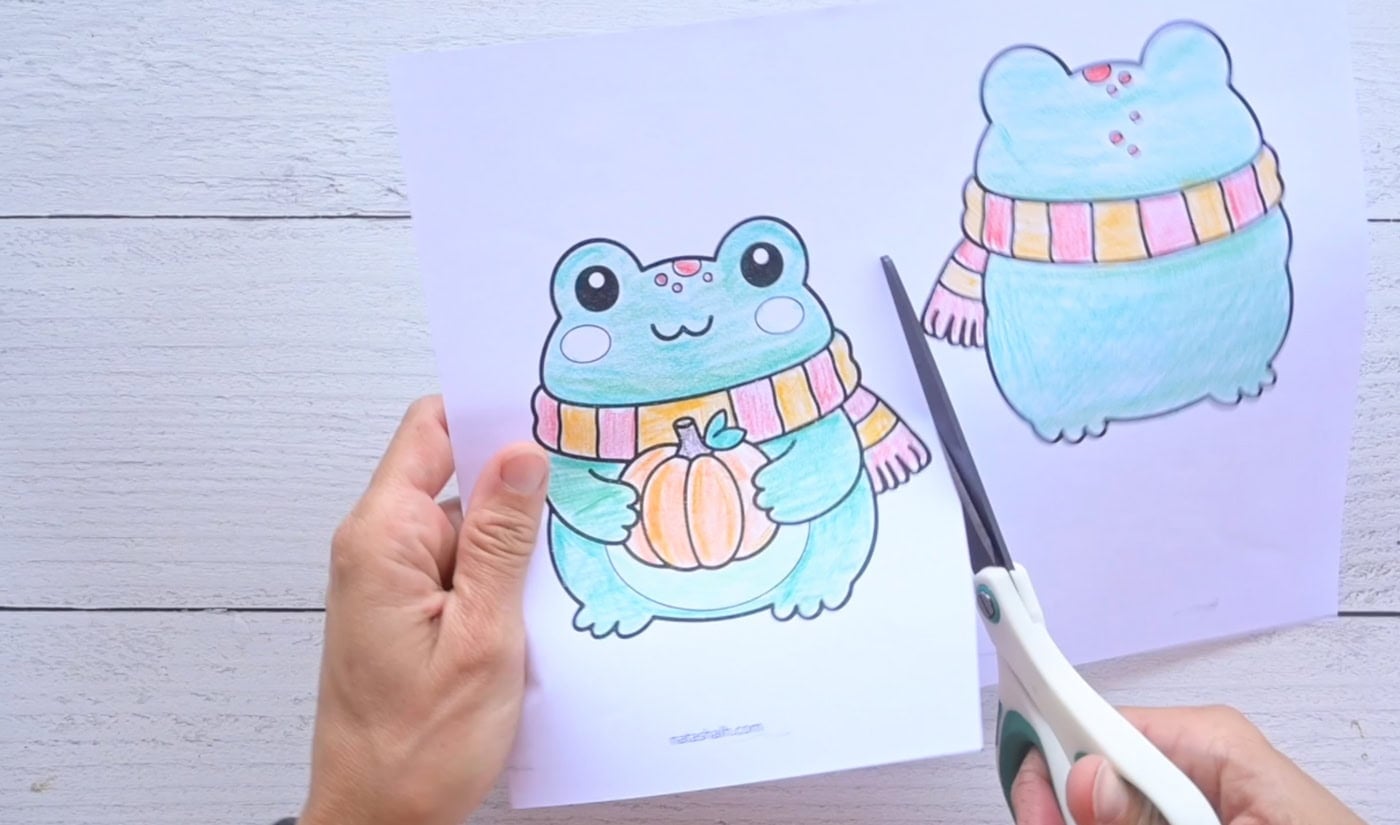 cutting out a paper frog squishy