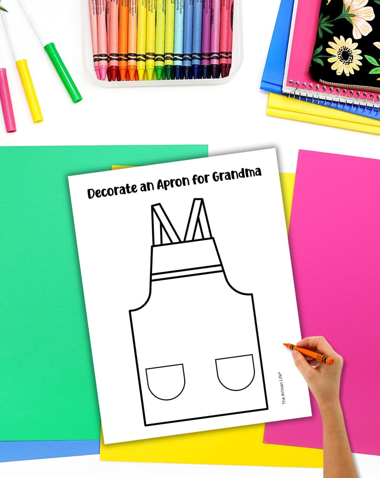 a hand preparing to color a "decorate an apron for grandma" craft