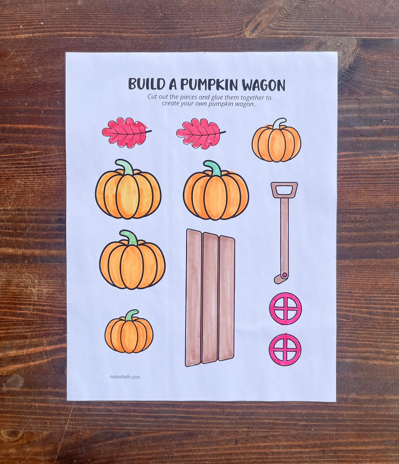 a photo of a pumpkin wagon cut and paste craft with all pieces colored