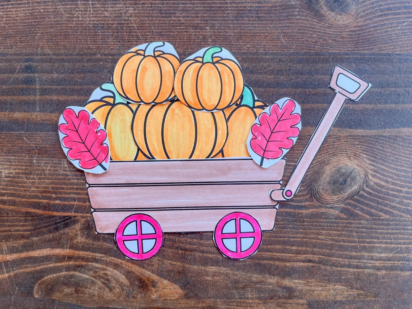 a photo of a pumpkin wagon cut and paste craft assembled